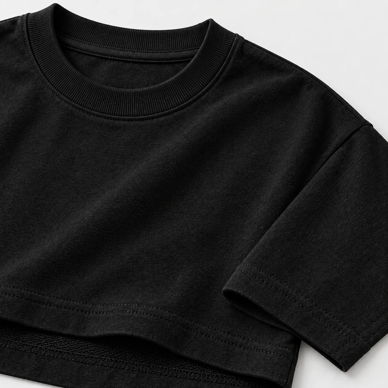 Close-up of the collar and shoulder of a heavyweight black t-shirt